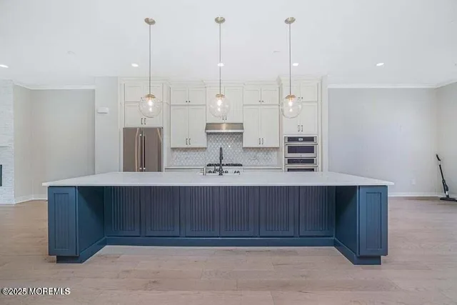 a view of kitchen with stainless steel appliances sink