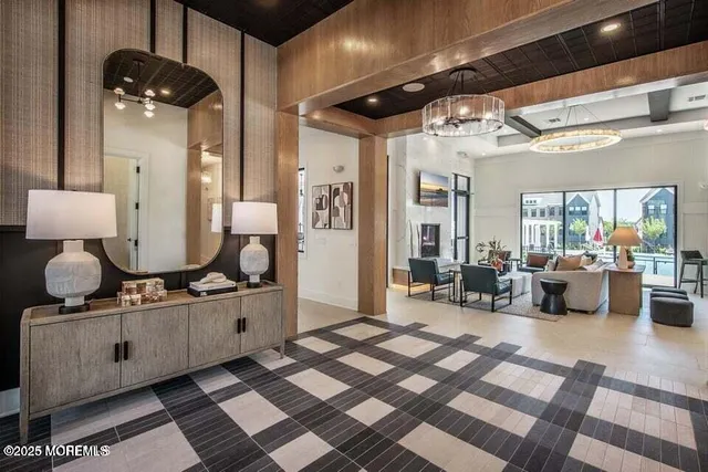 a living room with furniture and a chandelier