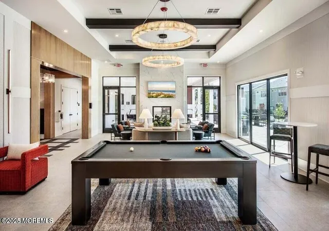 a view of a room with furniture and large windows