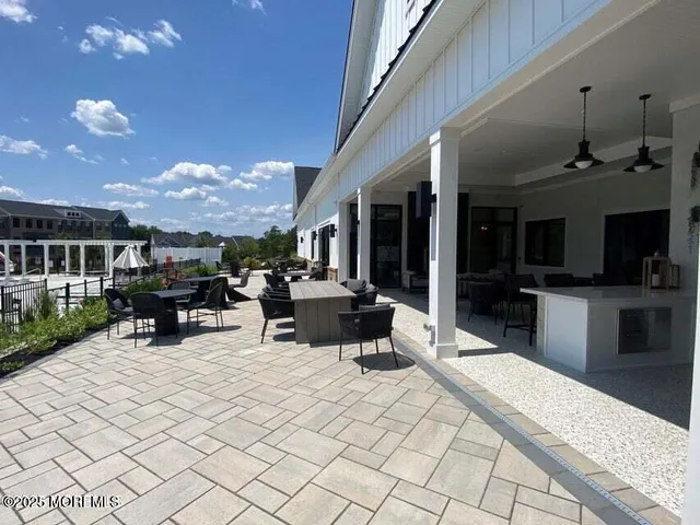 a view of a patio with dining table and chairs with a patio