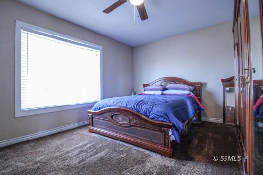 900 North Sierra View Street Ridgecrest, CA 93555 - Photo 30 of 42 a bedroom with a bed and a window