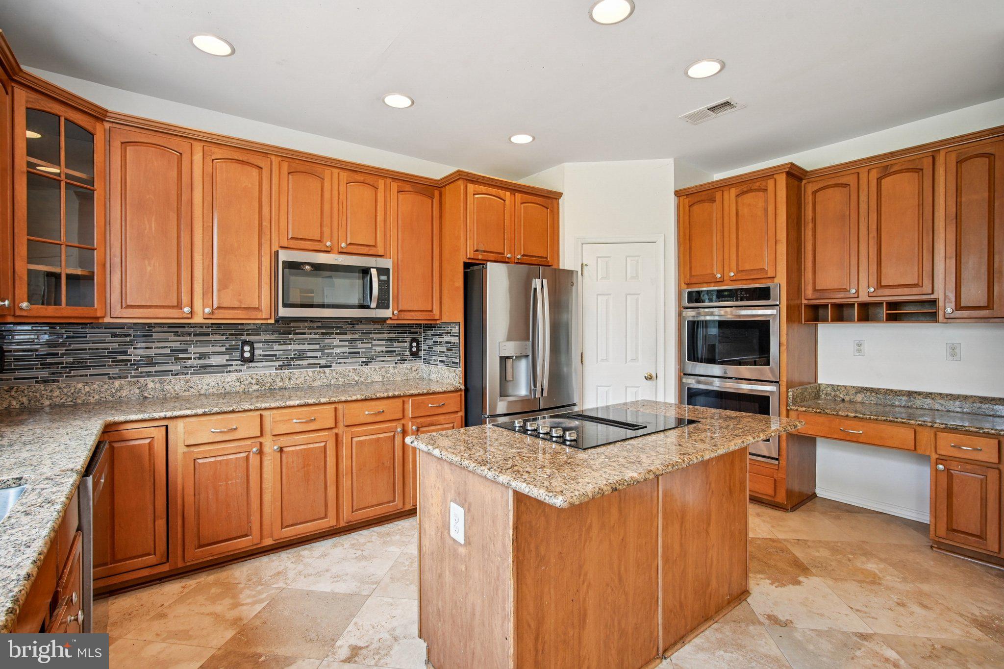 1624 Osprey Circle Cambridge, MD 21613 - Photo 15 of 45 a kitchen with stainless steel appliances granite countertop a stove top oven a sink dishwasher a refrigerator and cabinets with wooden floor