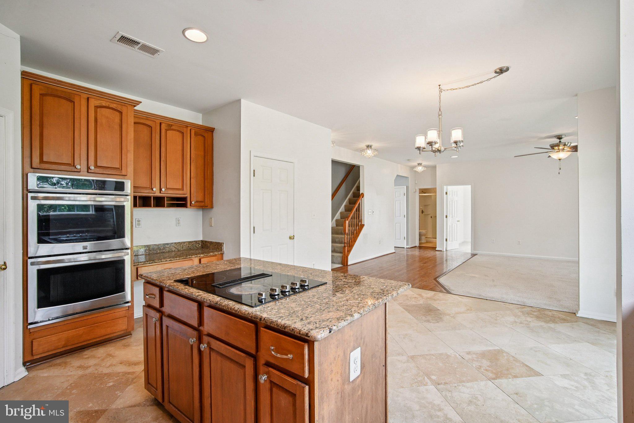 1624 Osprey Circle Cambridge, MD 21613 - Photo 17 of 45 a kitchen that has a stove and a wooden cabinets