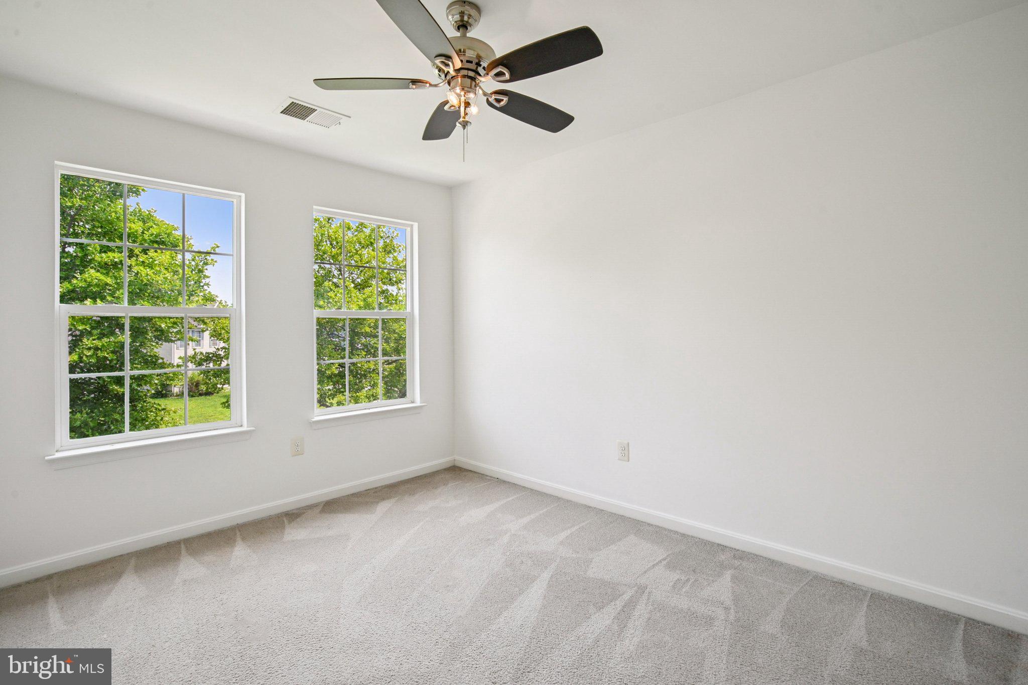 1624 Osprey Circle Cambridge, MD 21613 - Photo 26 of 45 an empty room with a window and a fan