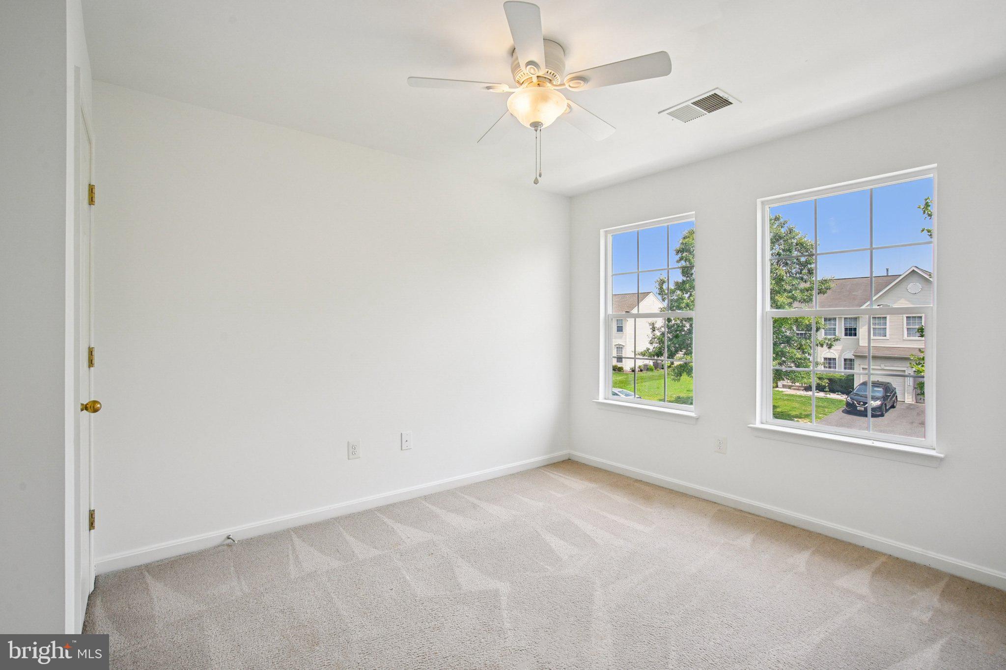 1624 Osprey Circle Cambridge, MD 21613 - Photo 29 of 45 an empty room with windows and fan