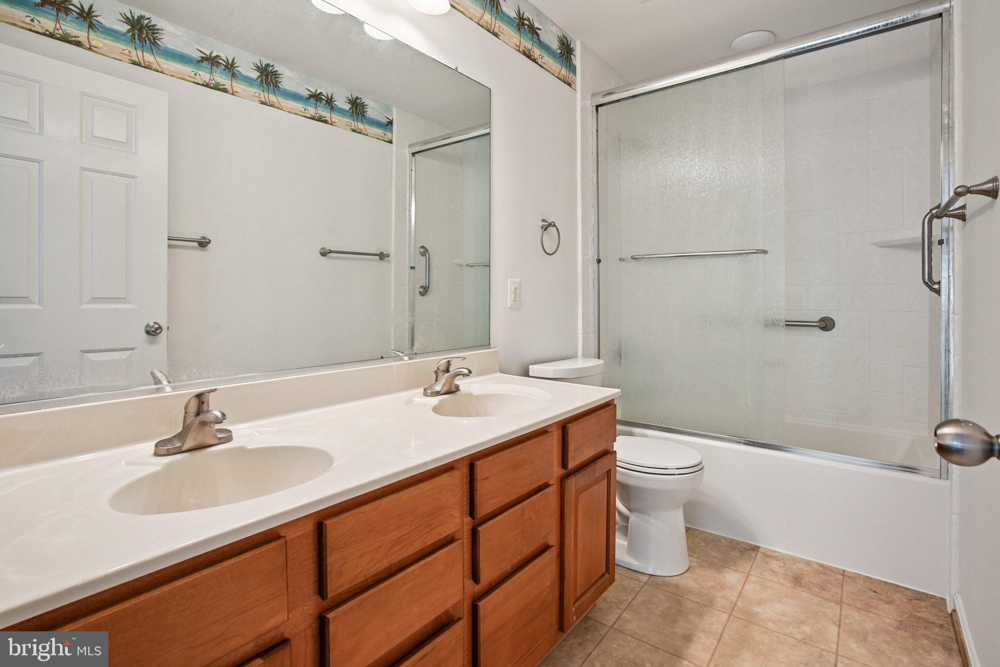 1624 Osprey Circle Cambridge, MD 21613 - Photo 30 of 45 a bathroom with a sink toilet a mirror and shower