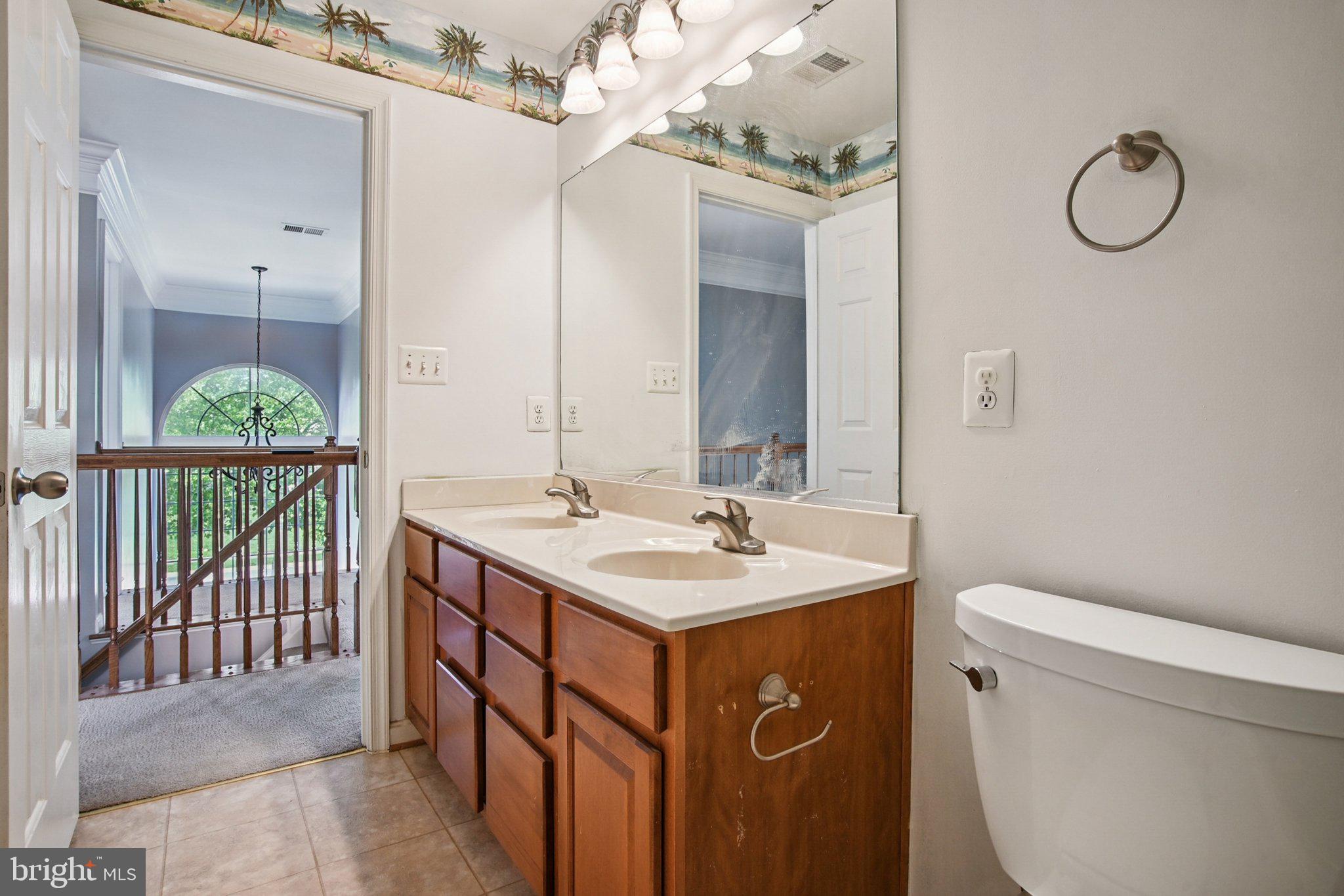 1624 Osprey Circle Cambridge, MD 21613 - Photo 32 of 45 a bathroom with a sink a toilet and a mirror