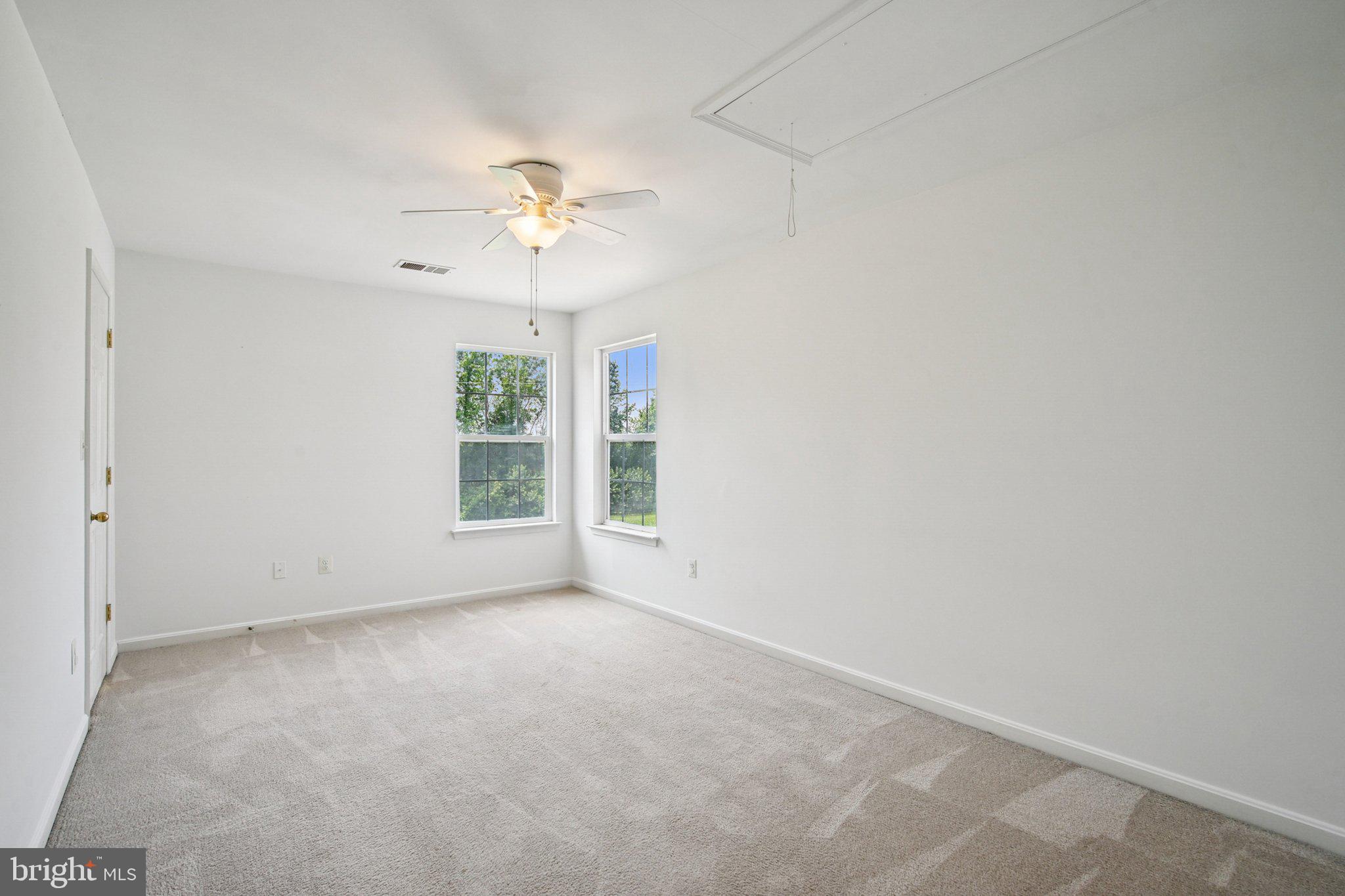 1624 Osprey Circle Cambridge, MD 21613 - Photo 33 of 45 an empty room with windows and fan