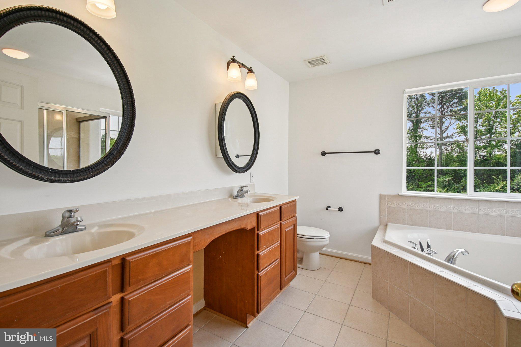 1624 Osprey Circle Cambridge, MD 21613 - Photo 38 of 45 a bathroom with a toilet a sink and a mirror