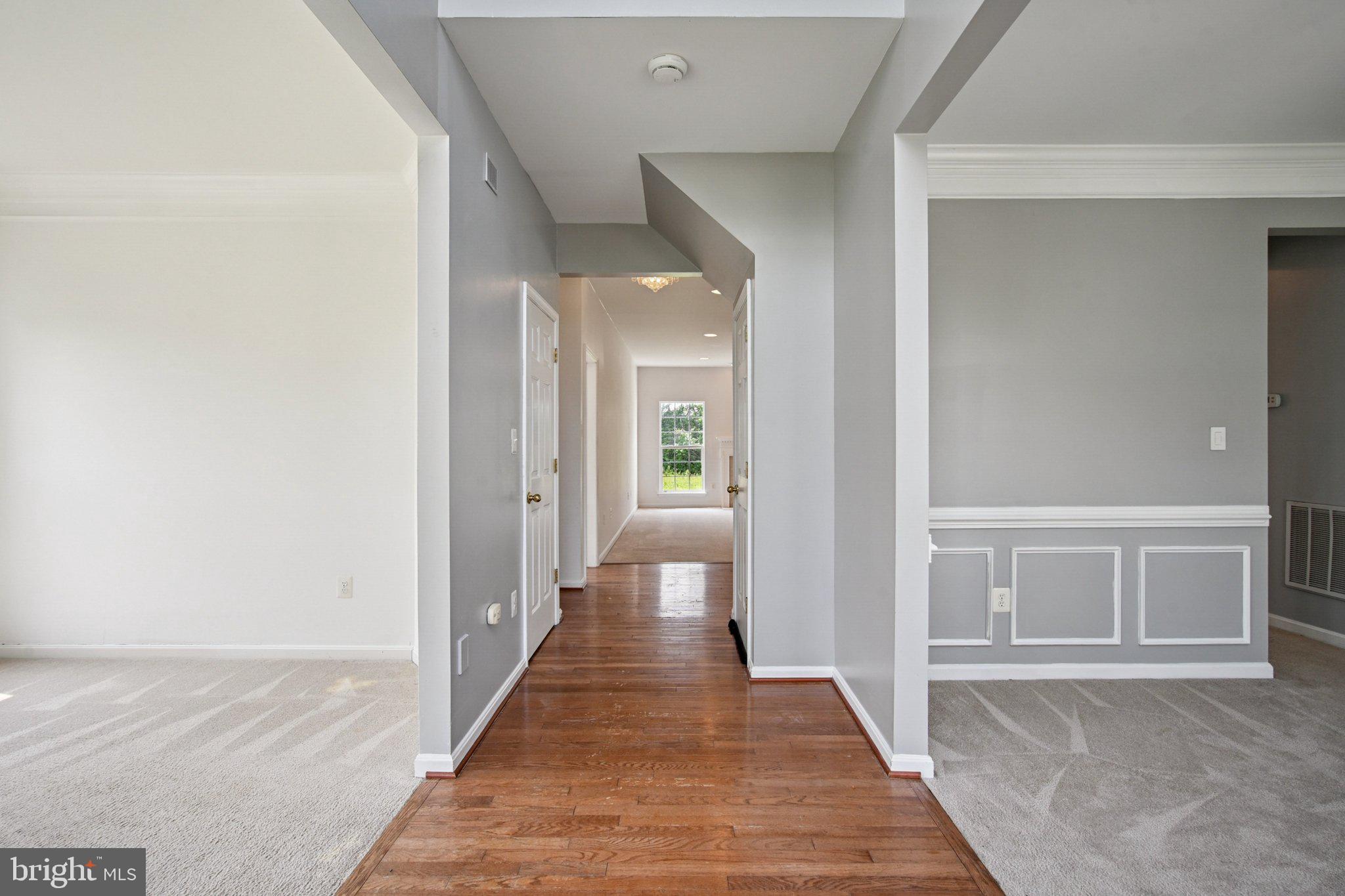 1624 Osprey Circle Cambridge, MD 21613 - Photo 4 of 45 a view of a hallway with wooden floor and a bathroom