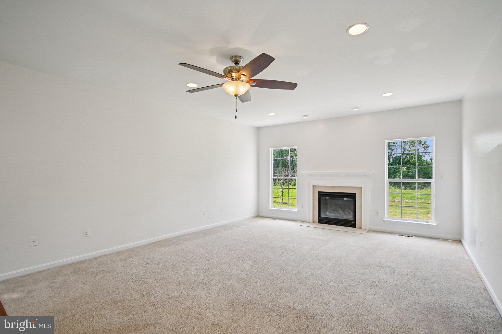 1624 Osprey Circle Cambridge, MD 21613 - Photo 5 of 45 a view of an empty room with a fireplace and a window
