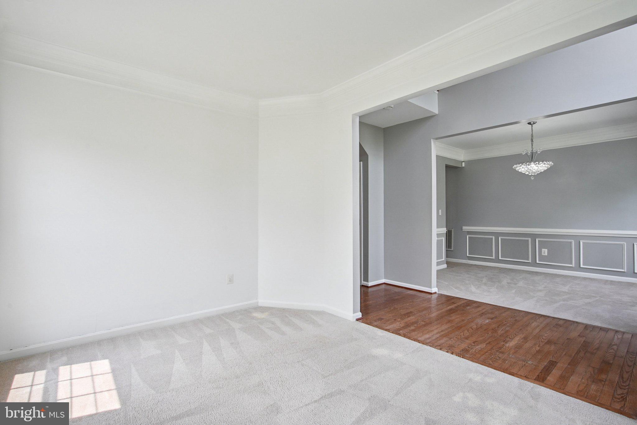 1624 Osprey Circle Cambridge, MD 21613 - Photo 7 of 45 an empty room with wooden floor and windows