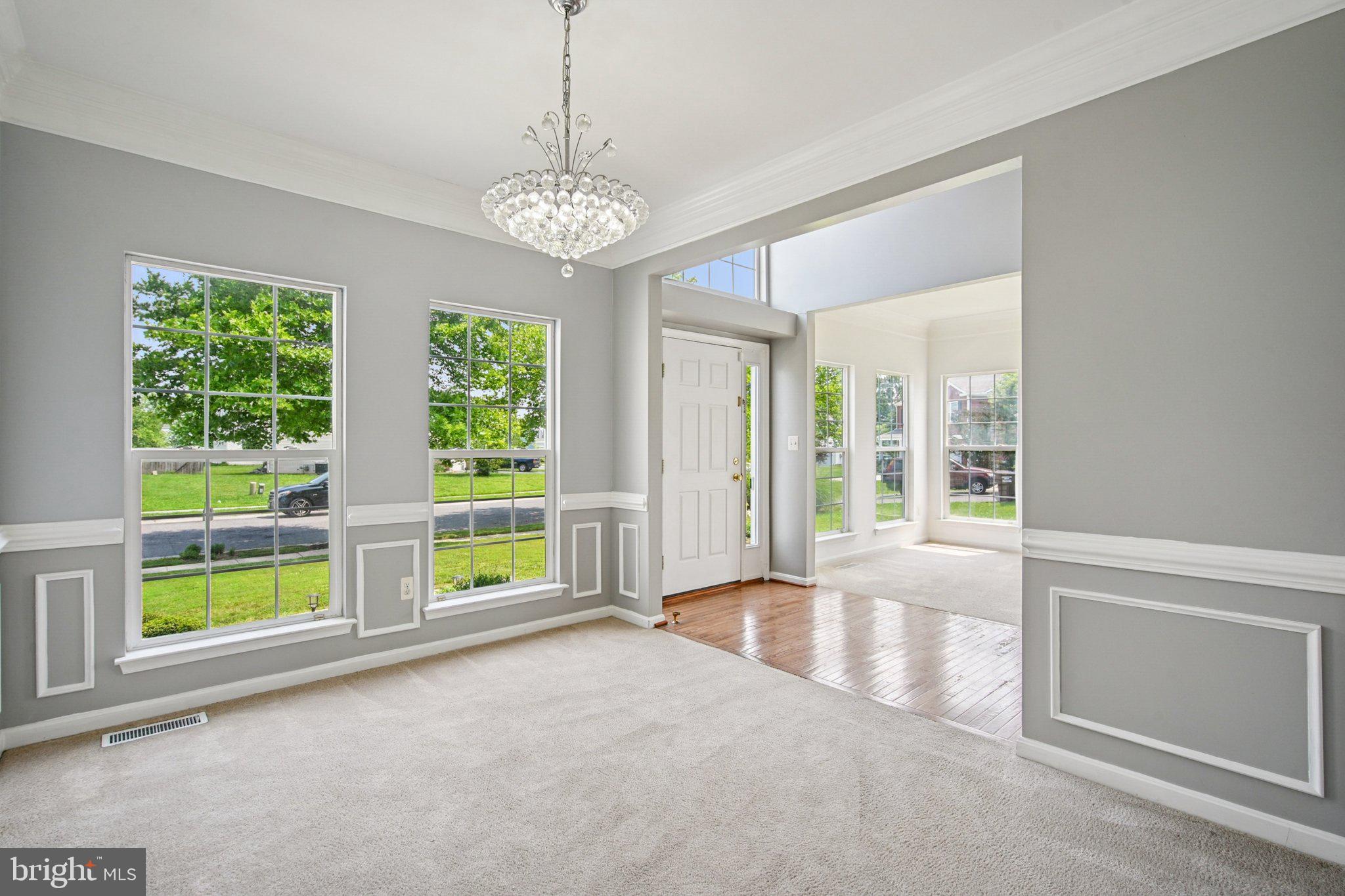1624 Osprey Circle Cambridge, MD 21613 - Photo 9 of 45 a view of an empty room with a window and chandelier