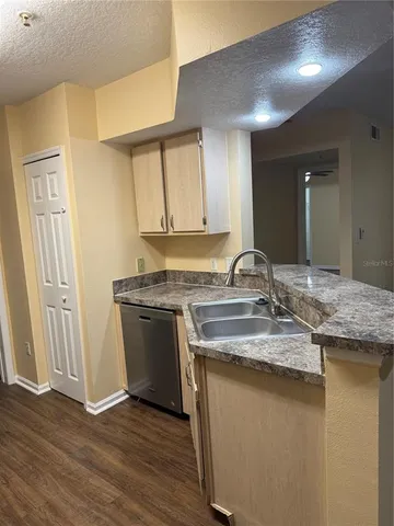 a view of a small space with wooden floor and a window