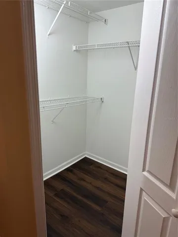 wooden floor in a hall with an empty room