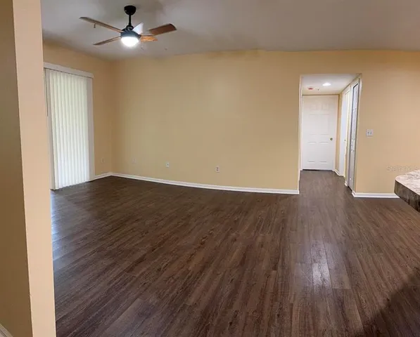 a kitchen with a refrigerator and a stove top oven