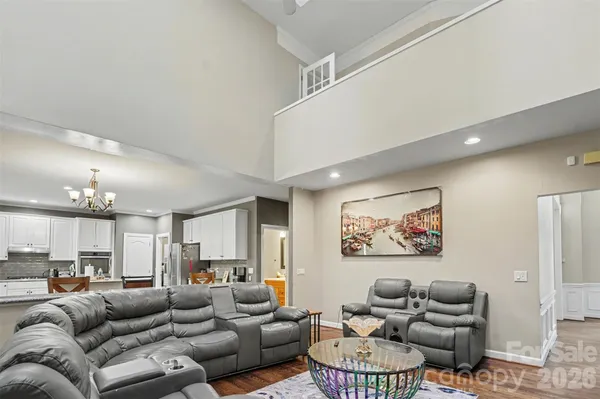 a kitchen with stainless steel appliances granite countertop a refrigerator sink and stove