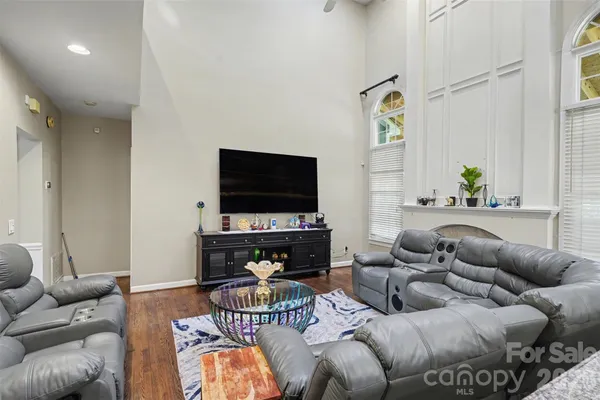a living room with furniture and a dining table
