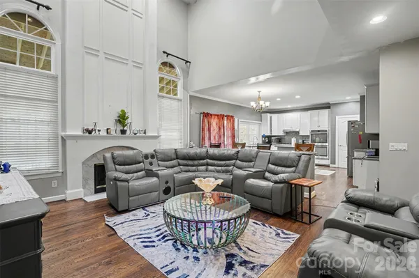 a spacious bedroom with a bed and a flat screen tv