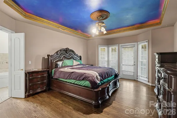 a bedroom with a bed and a chandelier