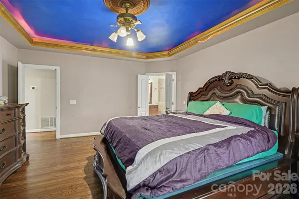 a bathroom with a granite countertop sink a mirror and shower