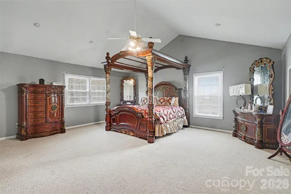 a bedroom with a bed window and walk in closet