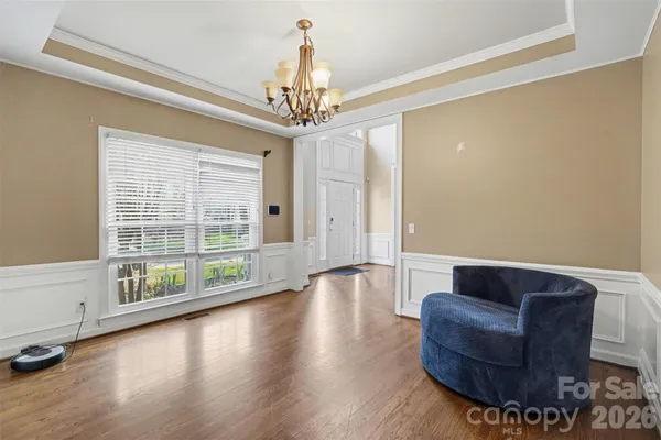 a living room with furniture and a chandelier