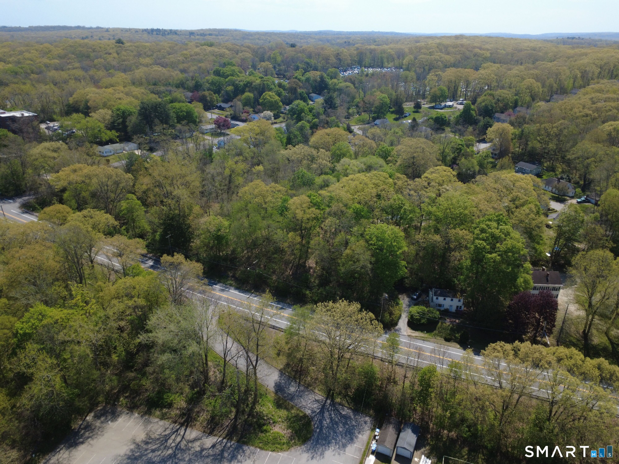 84 Corning Road Norwich, CT 06360 - Photo 11 of 12 a view of a forest with a street and trees