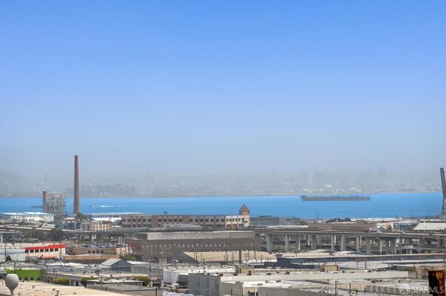 a view of a big room with window and wooden floor