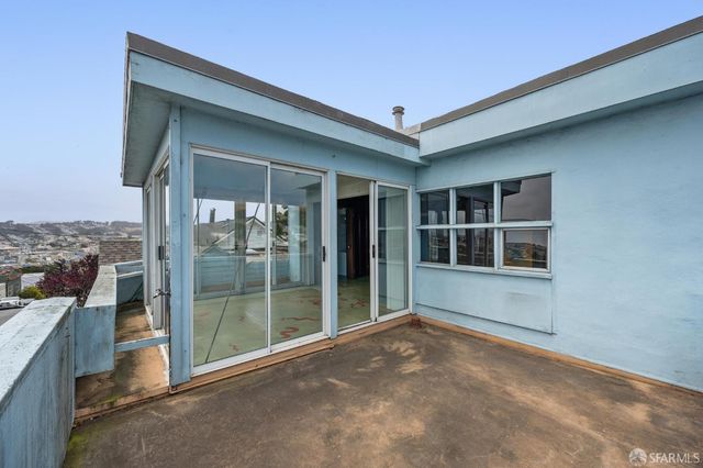 a view of a pathway of a house with wooden fence