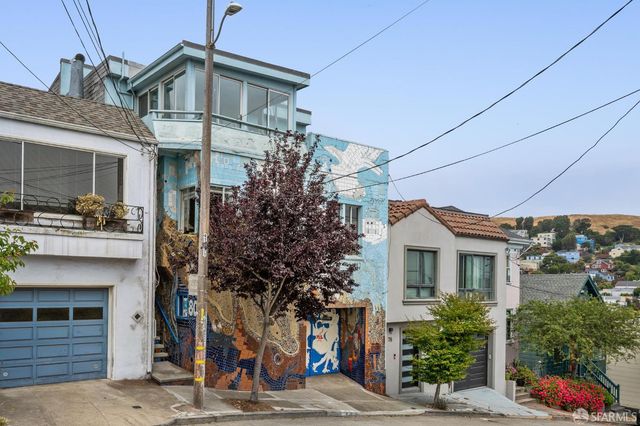 a large kitchen with stainless steel appliances granite countertop a refrigerator and a stove