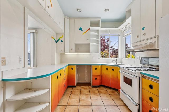 a kitchen with stainless steel appliances granite countertop a refrigerator a stove and a sink