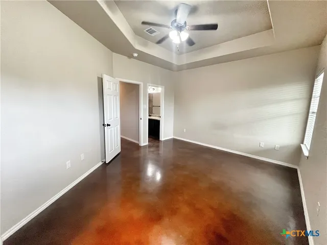 a bathroom with a granite countertop tub sink and mirror