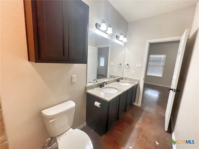 a view of an empty room with a chandelier fan