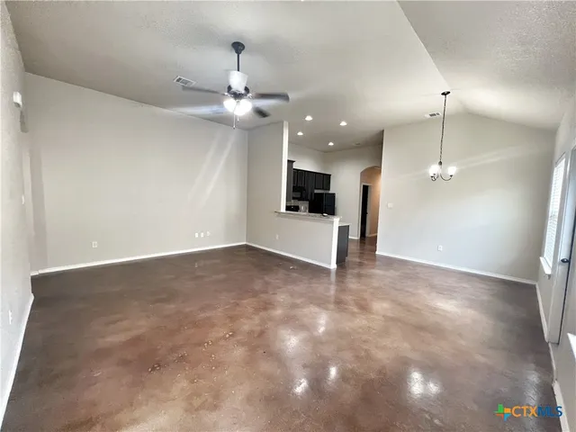 a kitchen with granite countertop a refrigerator and a sink