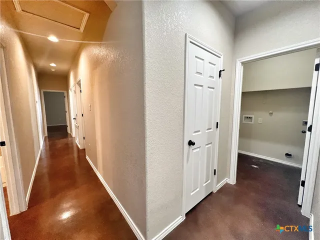 an empty room with a ceiling fan and a window
