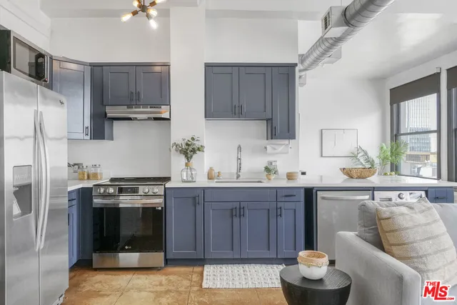 a kitchen with stainless steel appliances wooden cabinets and a stove top oven