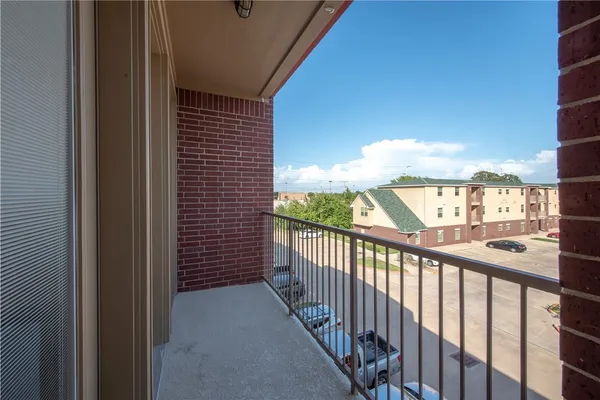 a view of a balcony with wooden floor