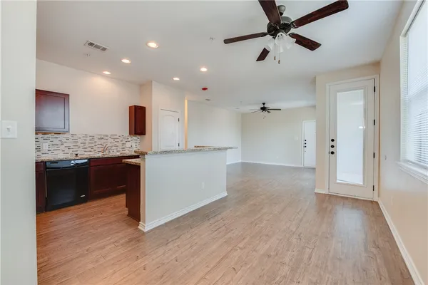 a open kitchen with kitchen island white cabinets and stainless steel appliances
