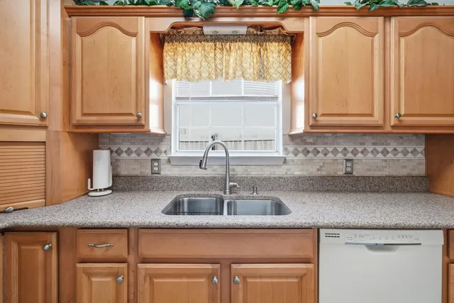 a kitchen with granite countertop a sink and a window