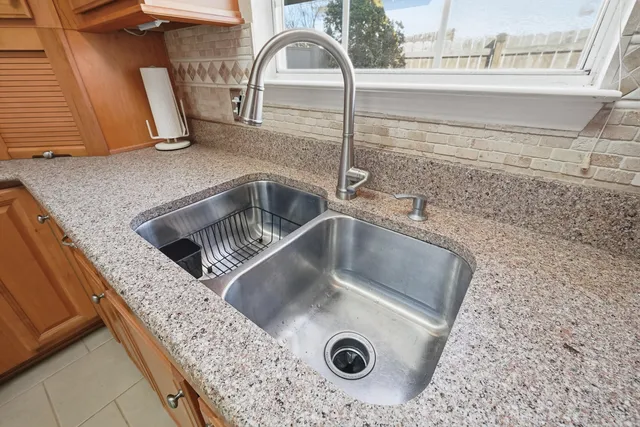a view of a sink a faucet and washer