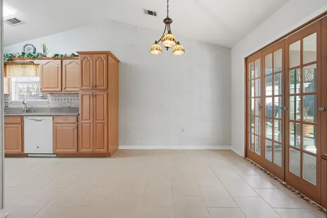 a view of kitchen with granite countertop cabinets and outdoor space