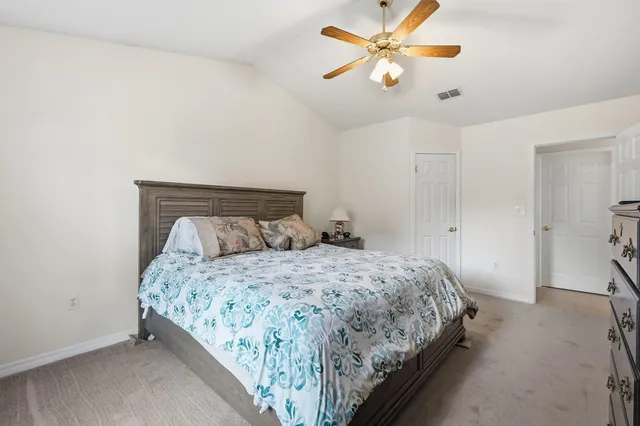 a bathroom with a granite countertop sink a toilet and shower