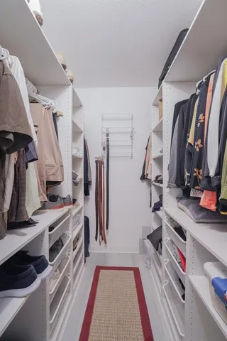 a living room with a floor to ceiling window and a table