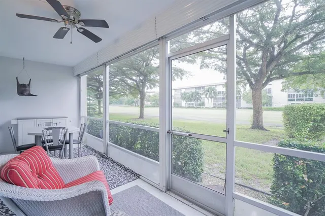 an aerial view of a city with lots of residential buildings ocean and mountain view in back