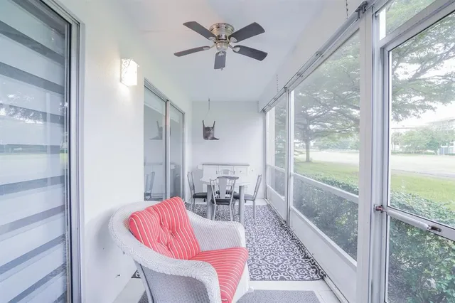a view of a tennis ground with large trees