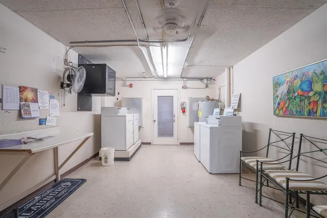 a outdoor space with lots of tables a large window and chairs