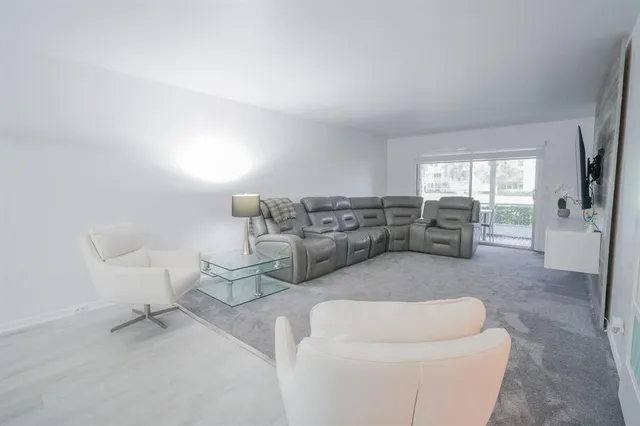 a living room with furniture and a chair