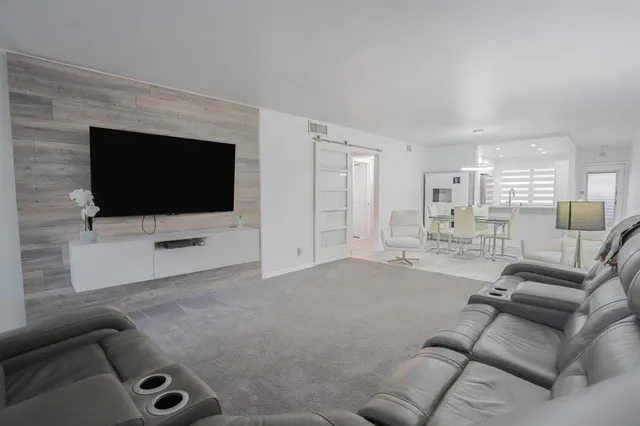 a bathroom with a granite countertop sink a toilet and a mirror