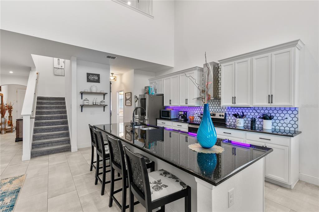 5637 Beggs Road St. Cloud, FL 34771 - Photo 30 of 35 a view of kitchen island with furniture and wooden floor